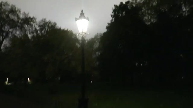 Glowing lamp beside a dark path in St James’s Park