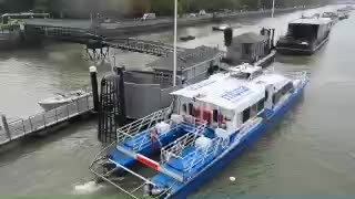 Thames river bus beside the pier during the London commute