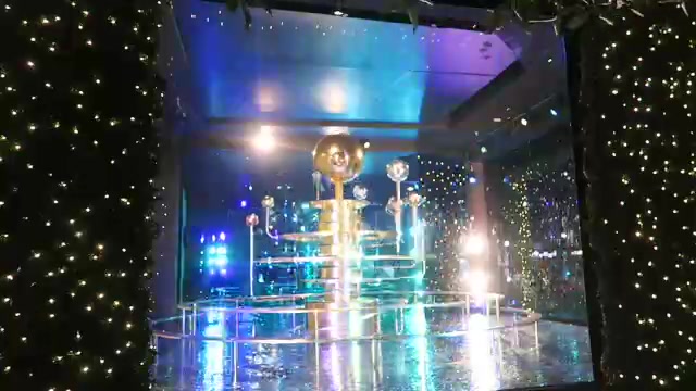 Colourful illuminated Christmas window with reflective display platforms