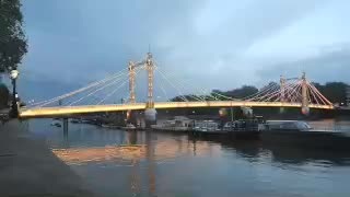 Albert Bridge illuminated above the Thames as daylight fades