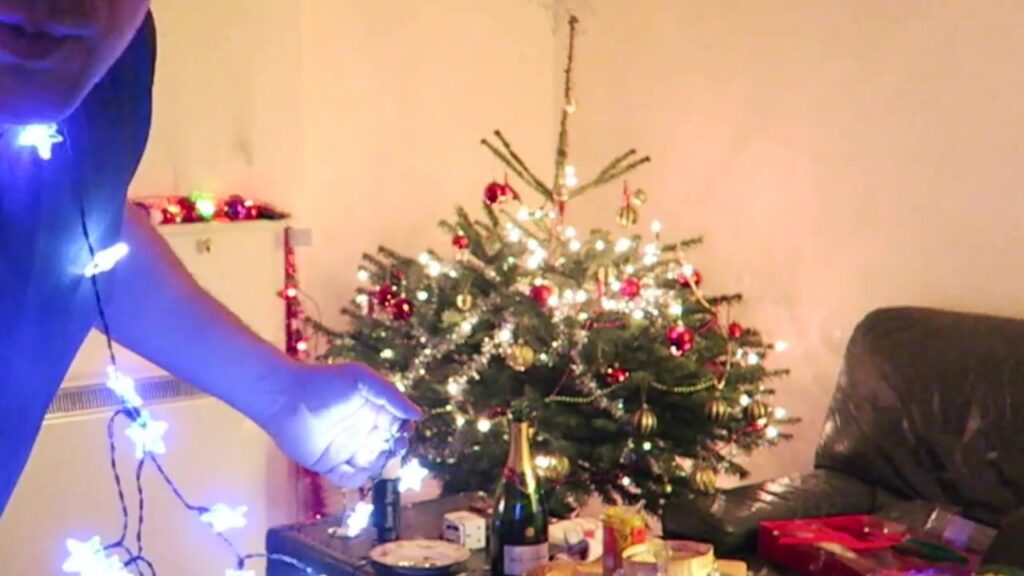 The Christmas tree glowing with lights and red decorations at the end of the evening.