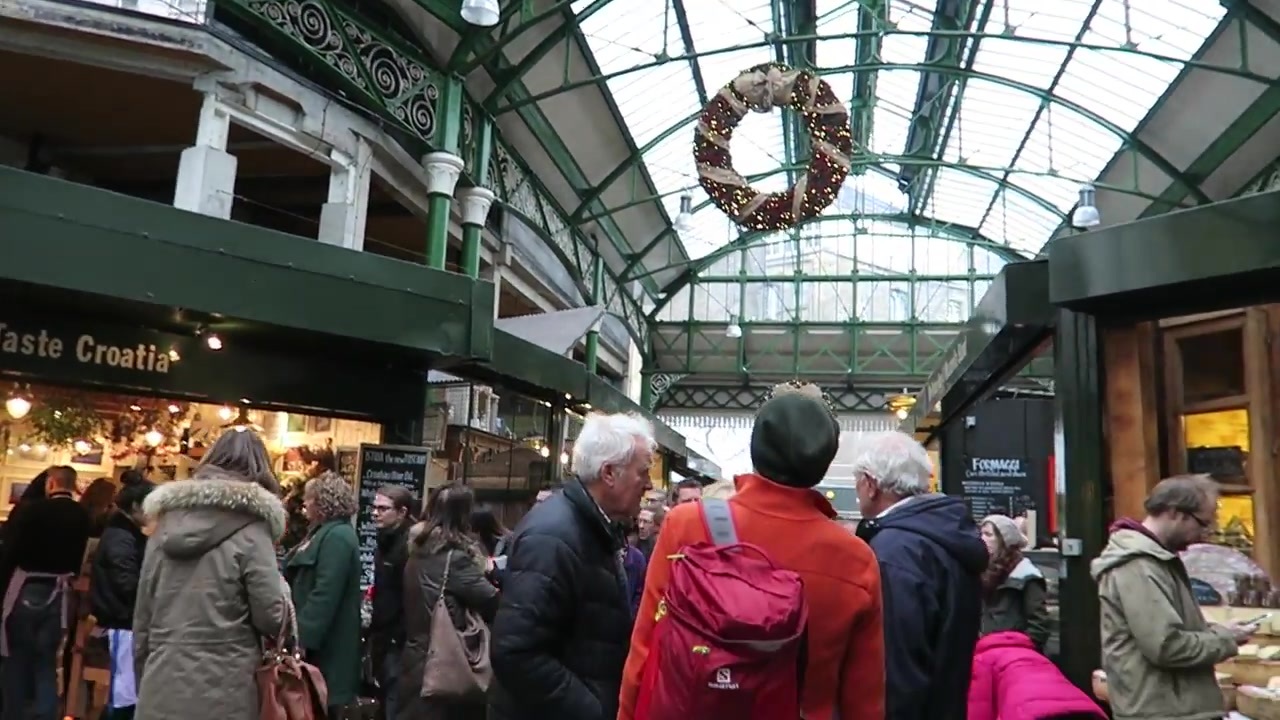 Shoppers beneath festive wreaths and the glass roof at Borough Market