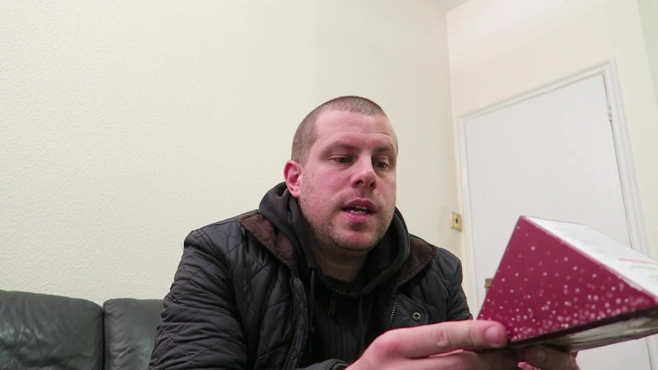 Barry holding the seasonal sandwich packaging at home