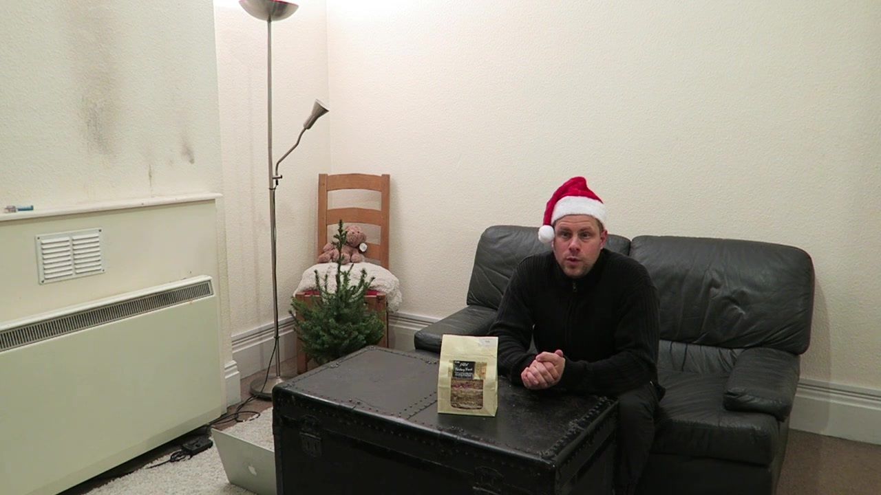 Barry introduces the Christmas-tree haul from the sofa wearing a Santa hat.