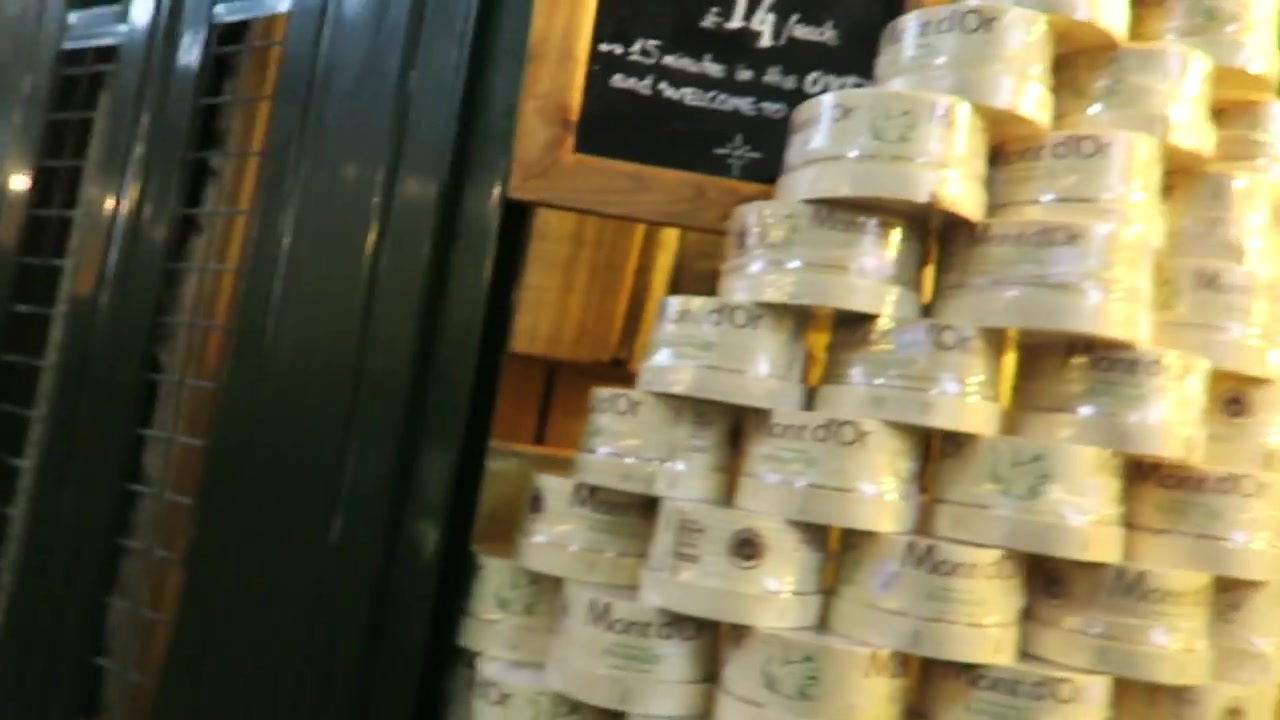 Stacked cheese boxes at a Borough Market stall