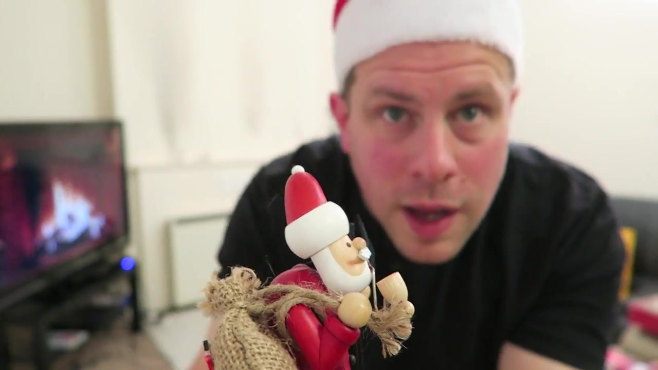 Barry holds a small Santa decoration close to the camera.