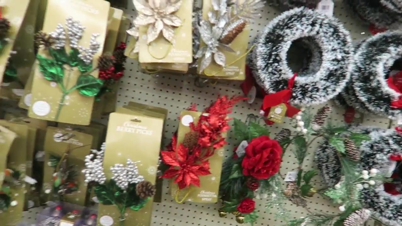 Christmas wreaths and decorative picks on a shop display