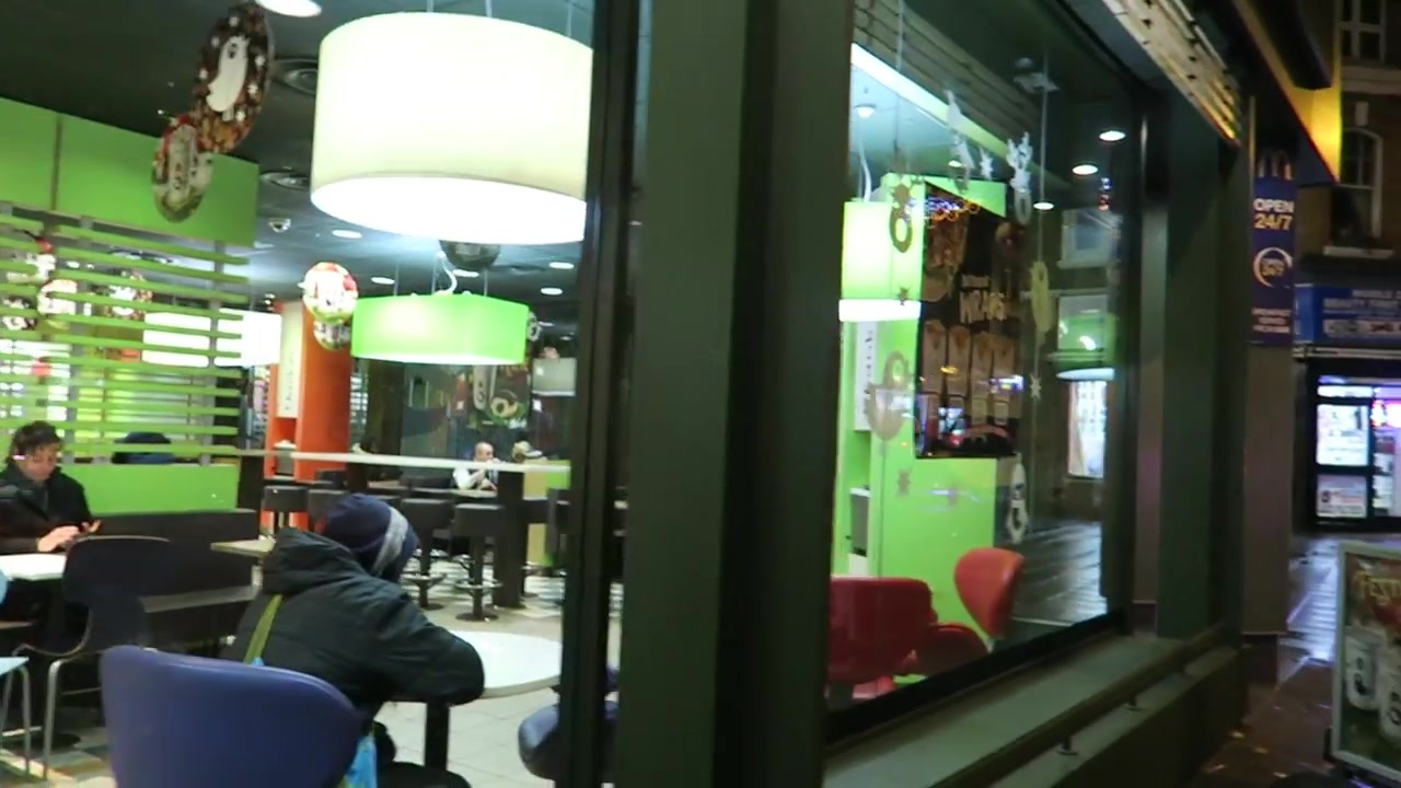 The brightly lit interior of McDonald’s viewed from outside