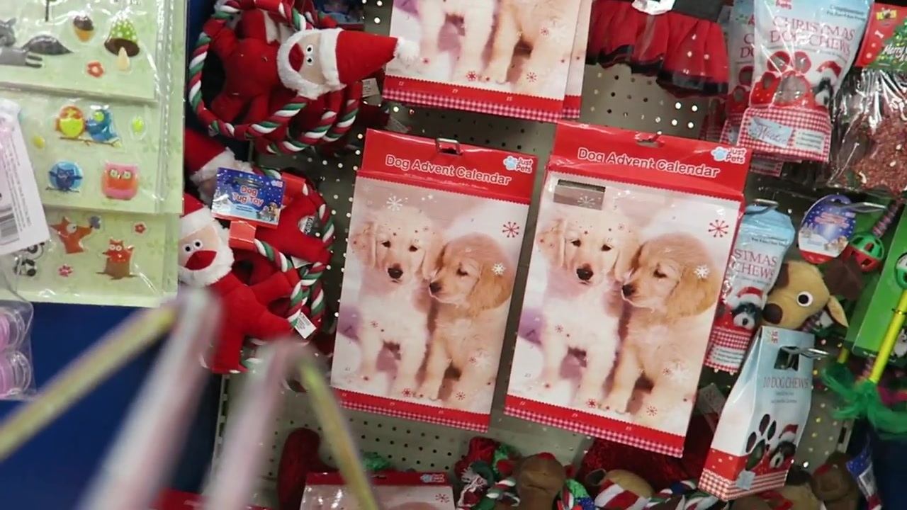 Christmas stockings with festive animal designs on a shop display