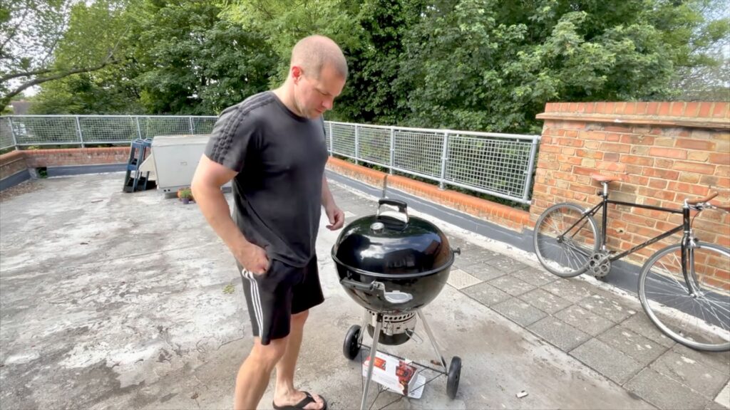 Weber Master-Touch charcoal barbecue set up on a London rooftop