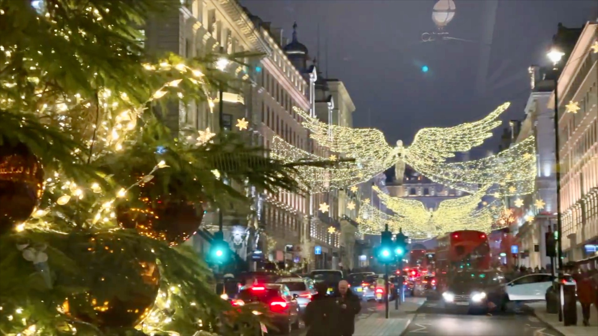 Christmas lights illuminating a busy central London street after dark during the festive season