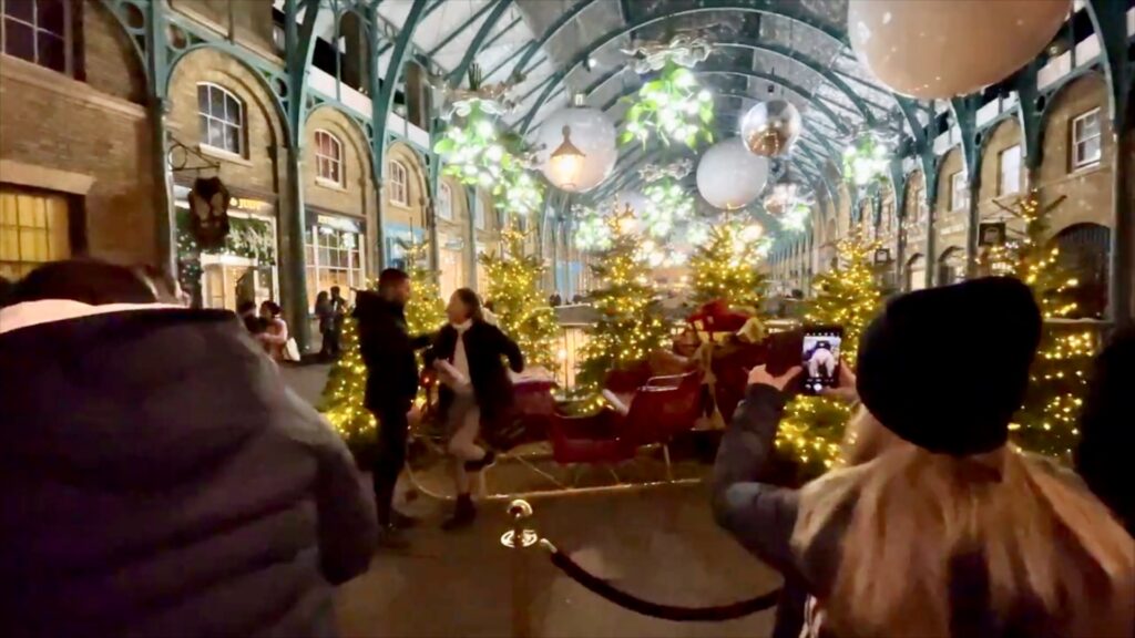 Visitors gathering around the decorated Covent Garden Market and Piazza during the Christmas season