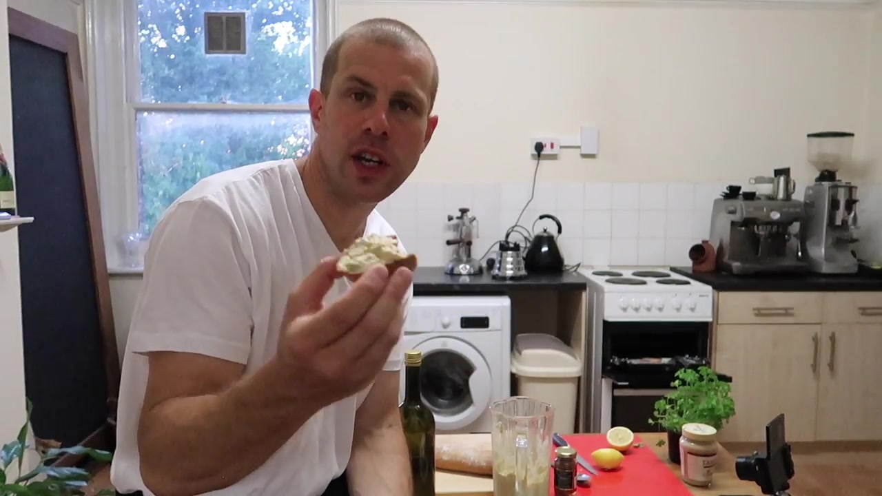 Barry Roberts holding a finished anchovy and chickpea crostini inspired by POLPO