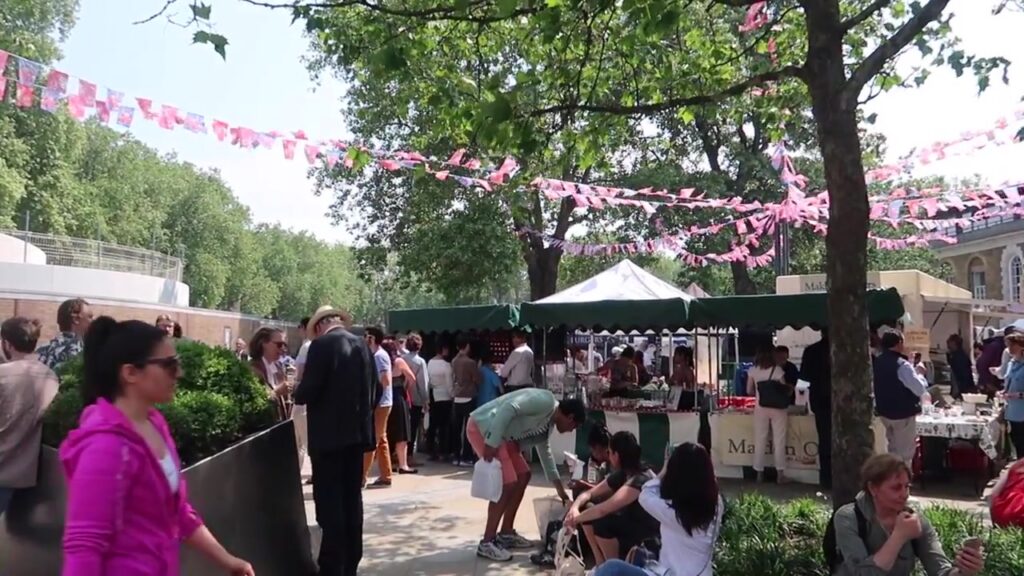 Partridges fine food shop and market crowd in Duke of York Square, Chelsea