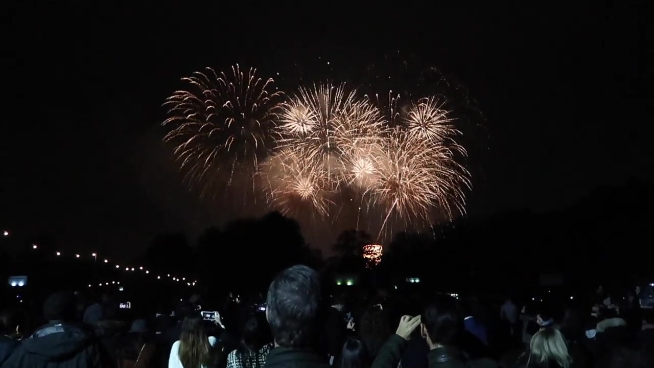 Golden fireworks exploding above Victoria Park during Guy Fawkes Night in East London