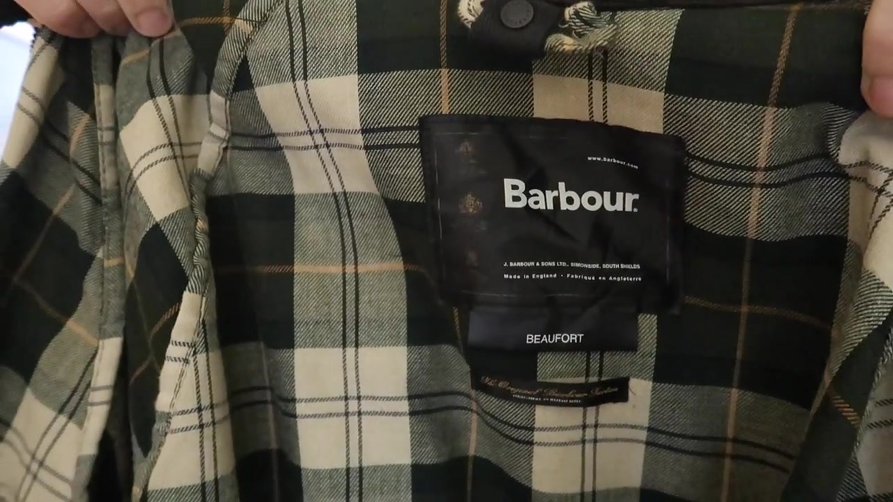 Close view of the Barbour Beaufort label and tartan lining inside Barry Roberts’s wax jacket.