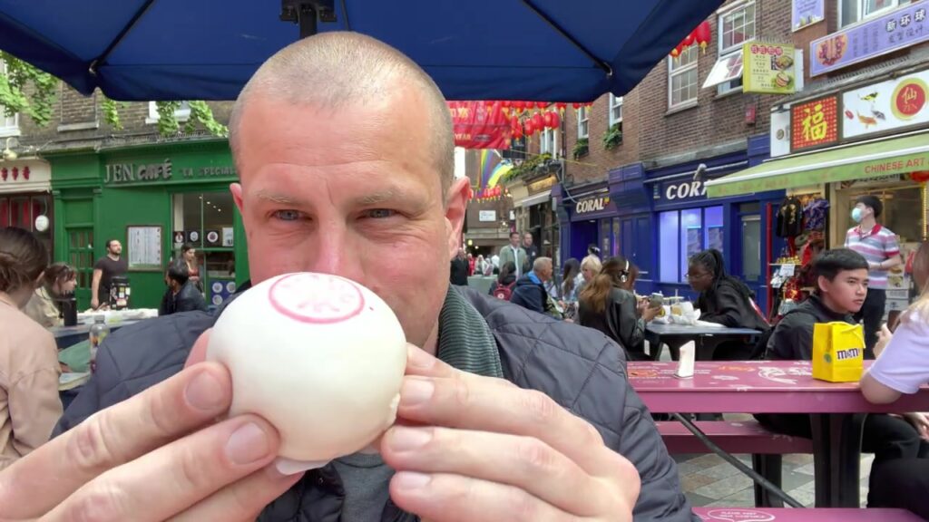 Barry Roberts holding a freshly steamed Bun House bun in London’s Chinatown in June 2022.