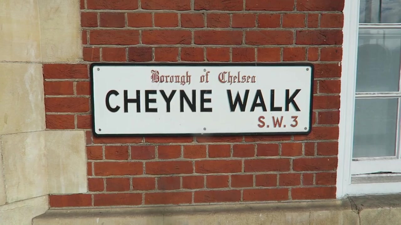 Cheyne Walk street sign on a red-brick wall in Chelsea