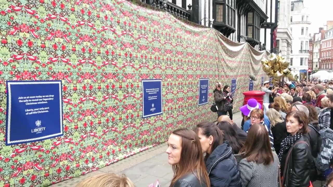 Liberty London’s Christmas windows covered in patterned fabric before the 2014 unveiling