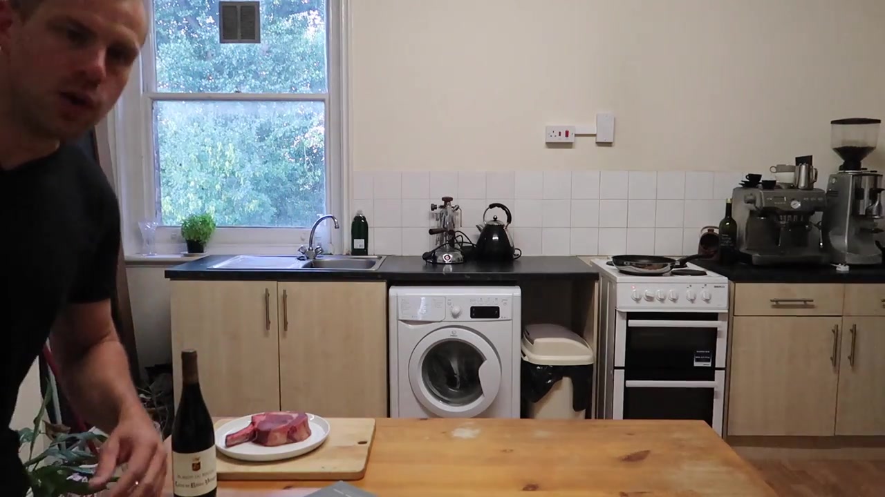 Barry Roberts introducing a home steak-cooking film in a London kitchen