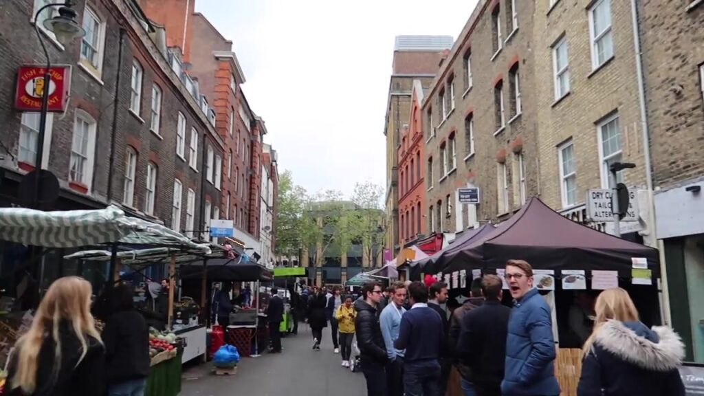 Leather Lane Market in London filled with weekday food stalls and lunchtime visitors
