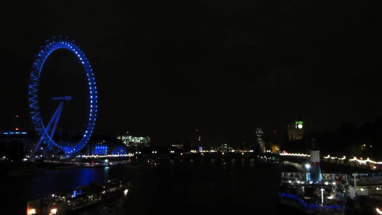 London Eye illuminated across the Thames at night in 2014
