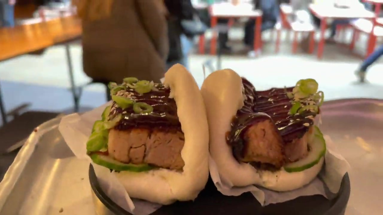 Two pork belly steamed buns with pickled cucumber and sesame at Yum Bun in Seven Dials Market.