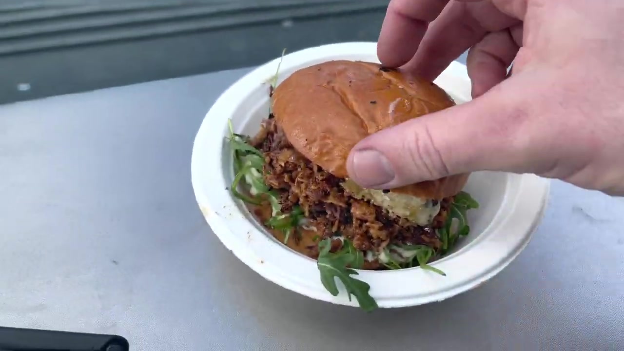 Duck confit burger with crisp onions, blue cheese and salad in a brioche bun at Southbank Centre Food Market.