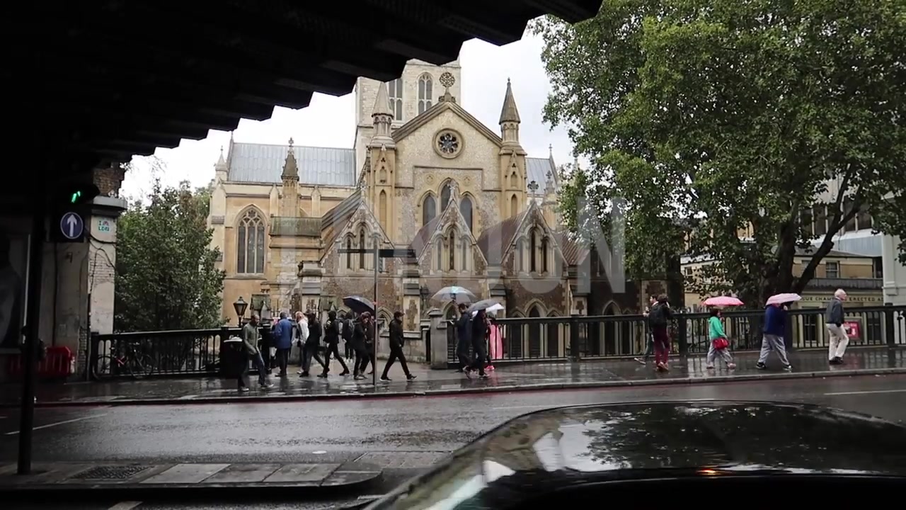 Southwark Cathedral viewed across a rain-soaked street near Borough Market