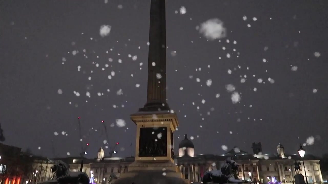 Snow falling around Trafalgar Square and Nelson’s Column in a Roberts London Christmas film