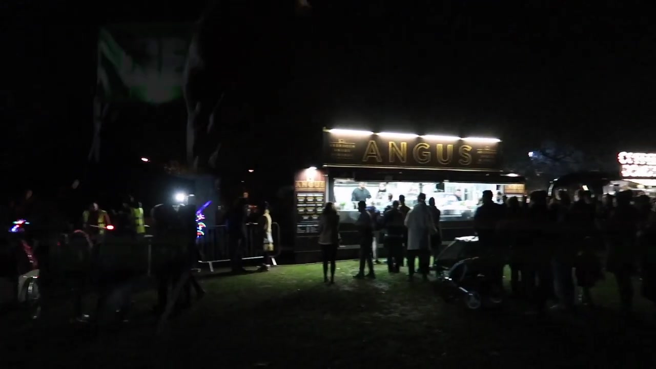 Illuminated food stalls serving visitors at the Victoria Park fireworks event