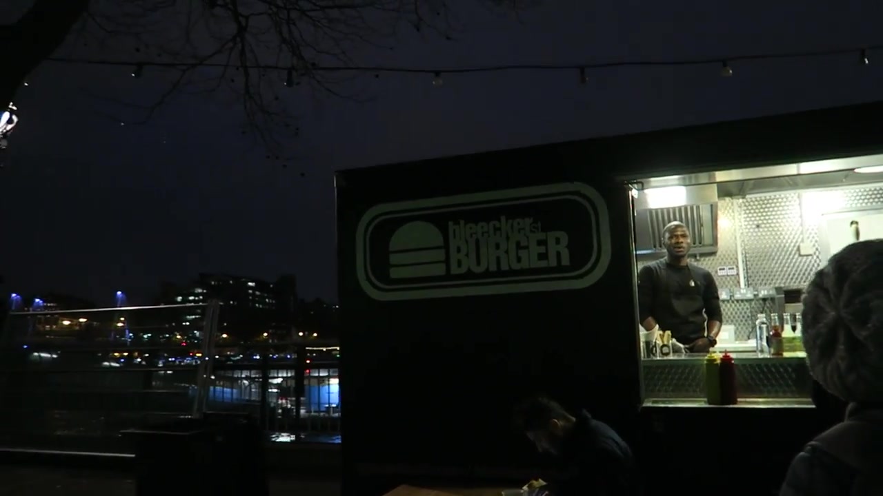 Bleecker Burger food truck serving customers beside the River Thames