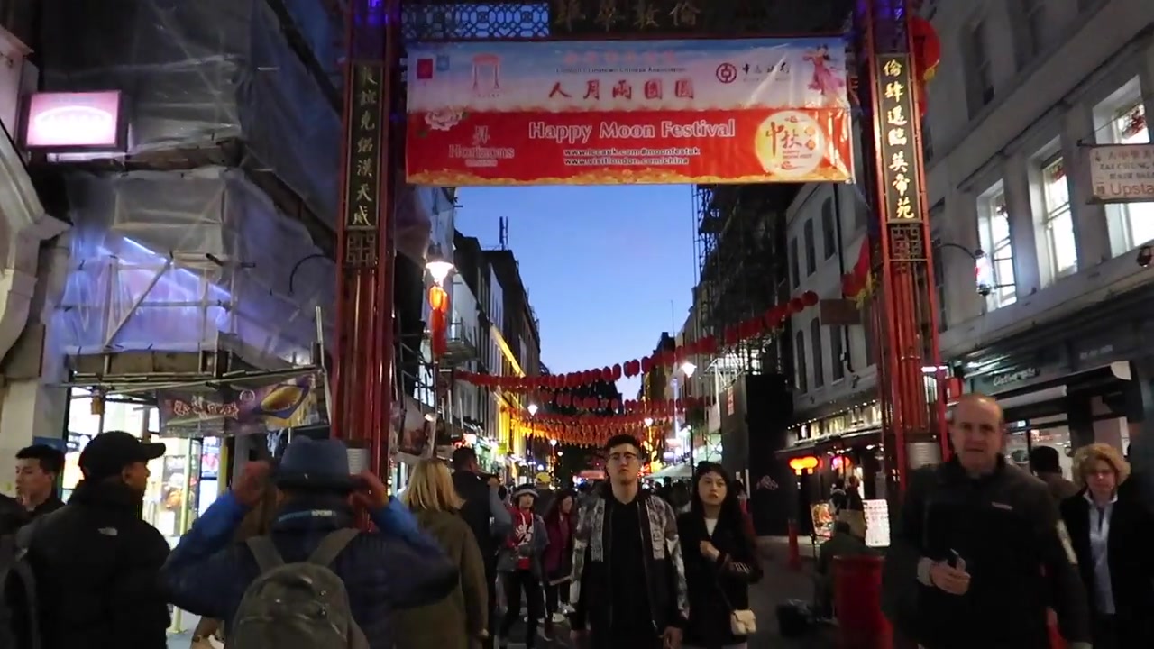 Rows of red lanterns hanging above the streets of London Chinatown at night
