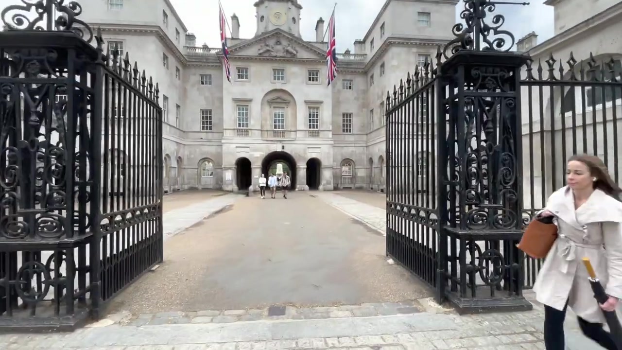 Clock tower and central arch of Horse Guards viewed through its open iron gates