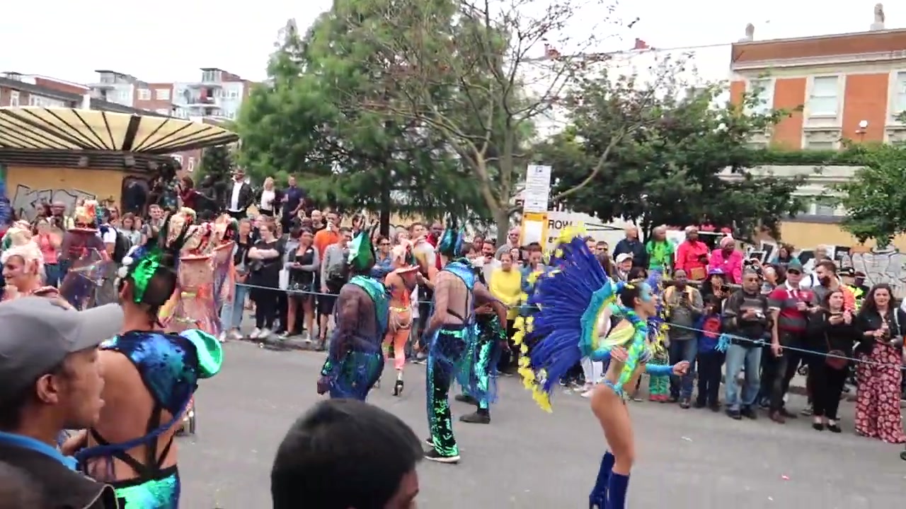 Dense crowds filling a residential street at Notting Hill Carnival in London in 2018