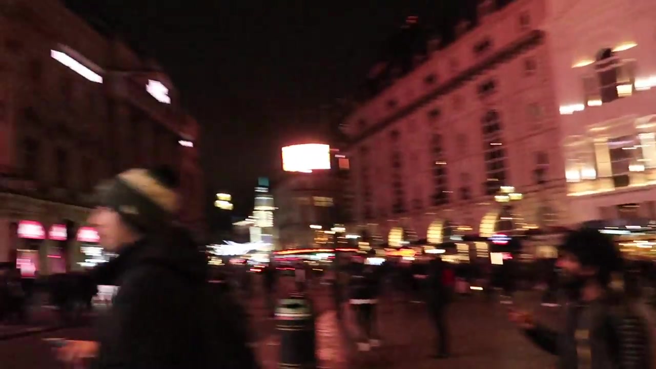 Evening crowds and illuminated buildings around Piccadilly Circus in November 2019