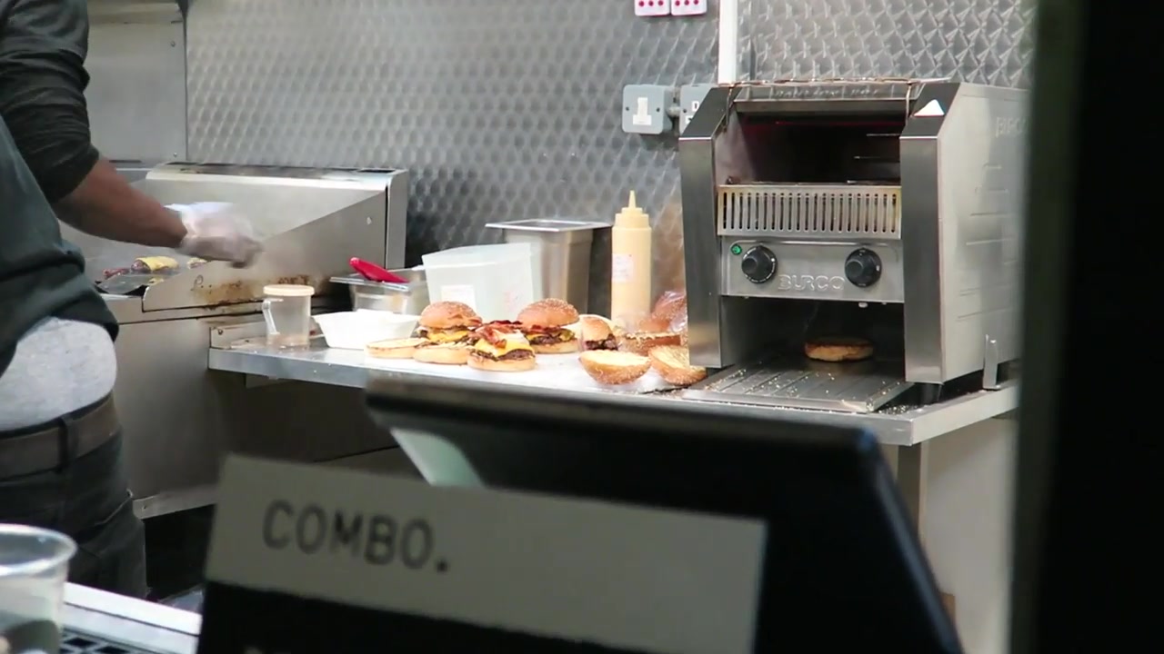 Burgers being assembled inside the Bleecker Burger food truck