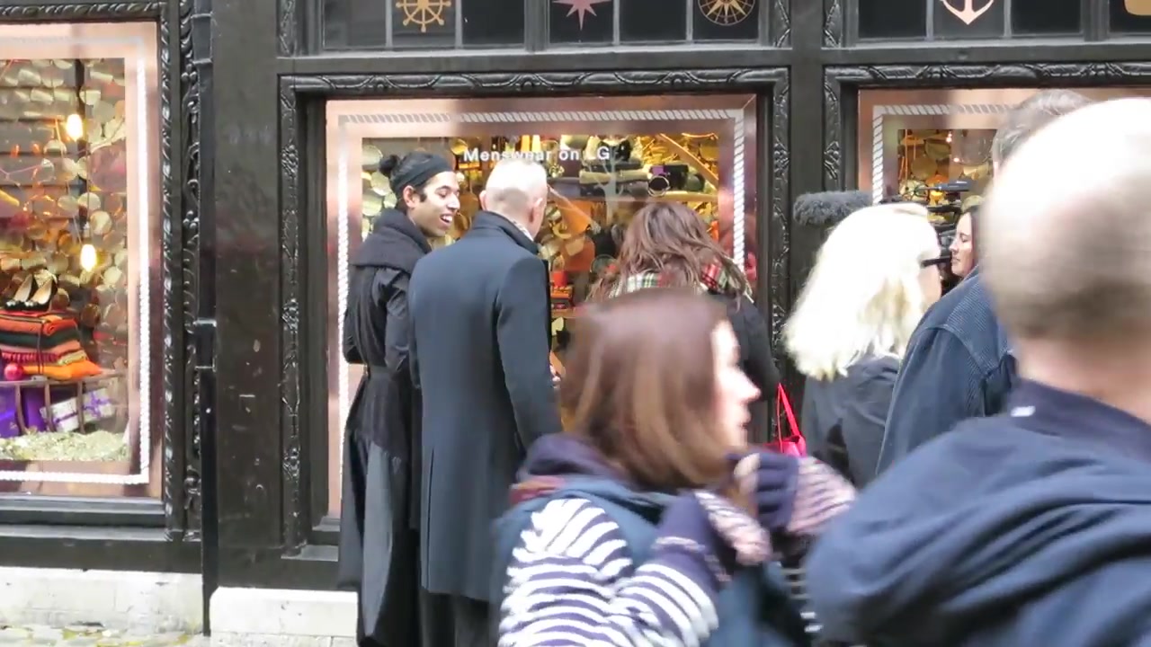 Shoppers gathering around Liberty London after its 2014 Christmas windows were revealed
