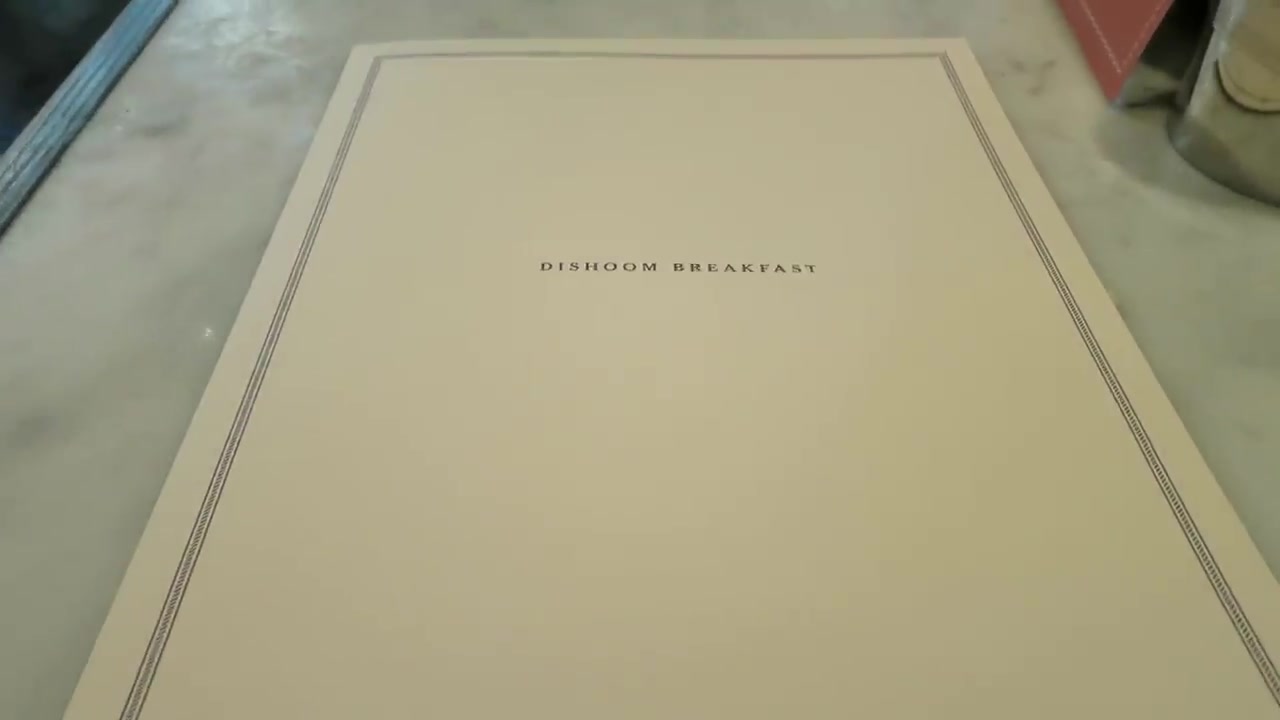 Dishoom breakfast menu on a restaurant table