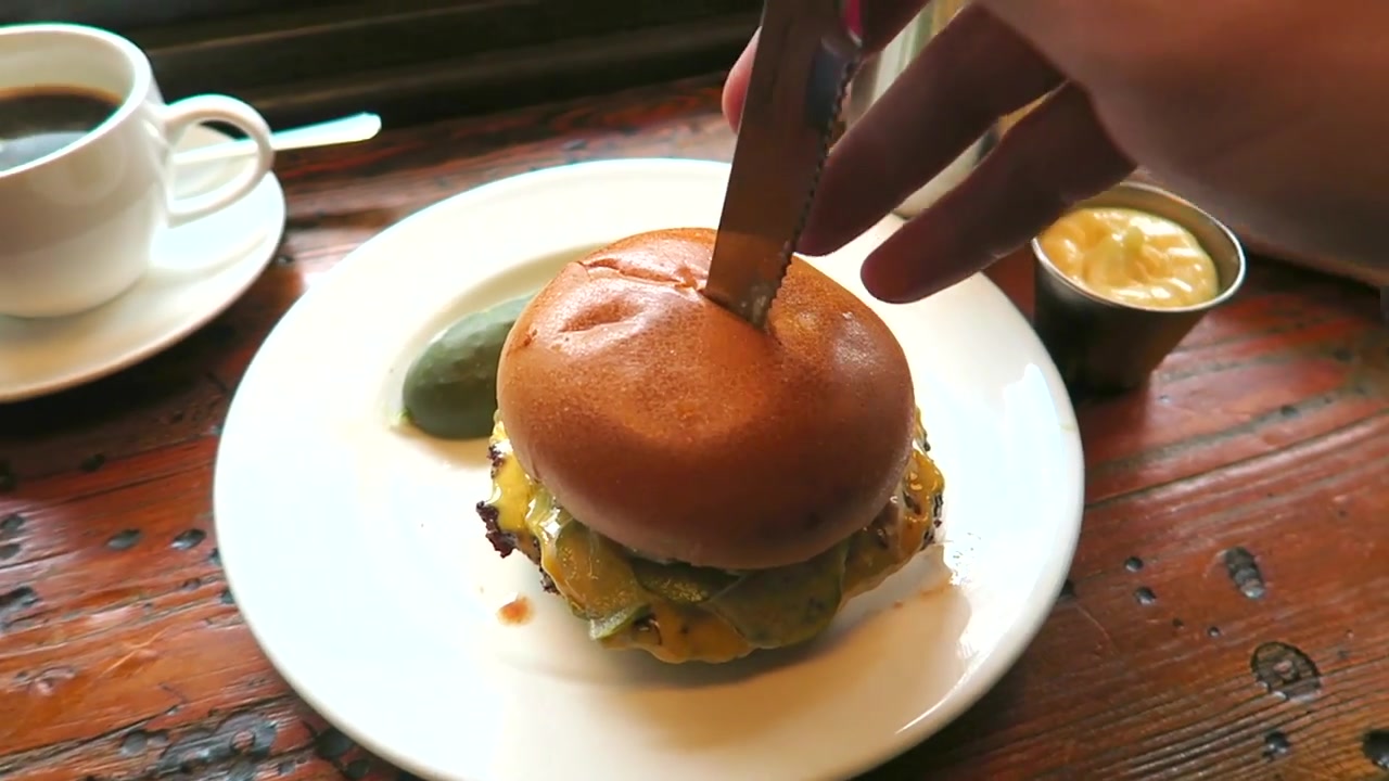 Burger served with a pickle at the Electric Diner on Portobello Road