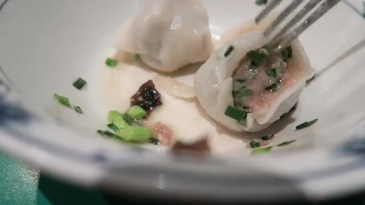 Opened Beijing dumpling with meat and green vegetable filling at Jen Café