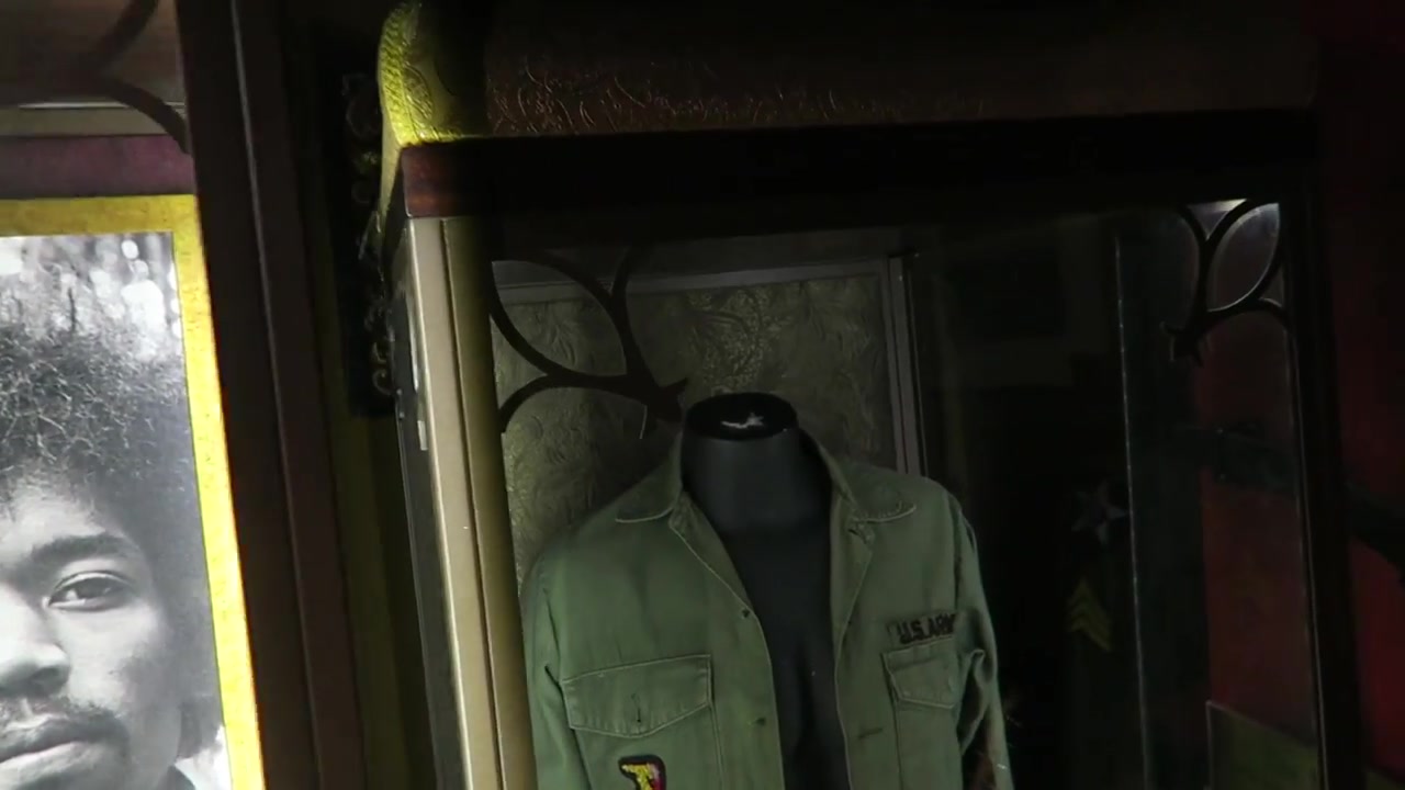 Jimi Hendrix portrait and military-style clothing displayed inside the London vault