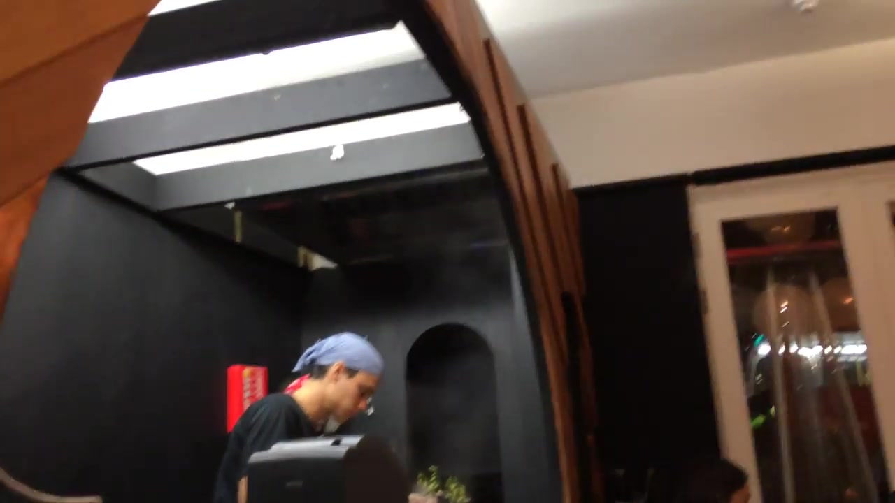 Chef working in the open kitchen at Kanada-Ya on St Giles High Street in London