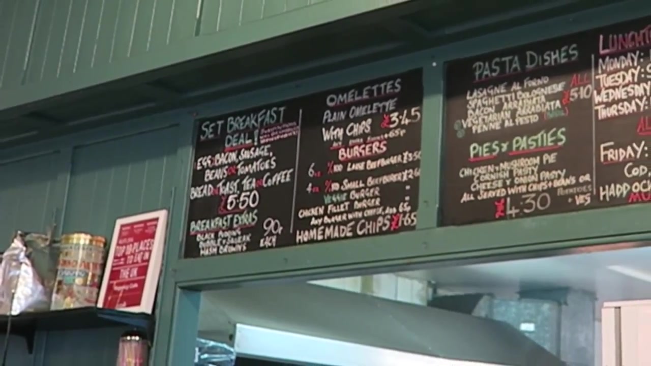 Handwritten 2016 Regency Café menu boards above the kitchen counter.