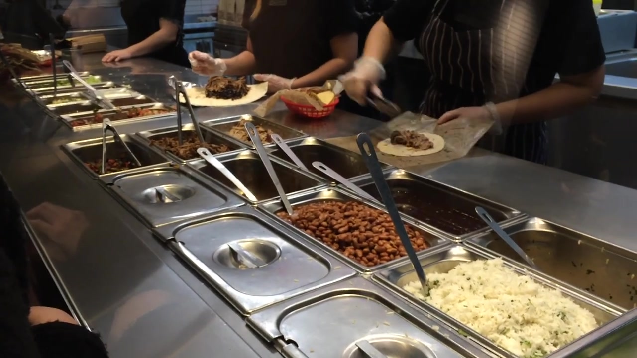 Rice and beans arranged along the Chipotle burrito counter