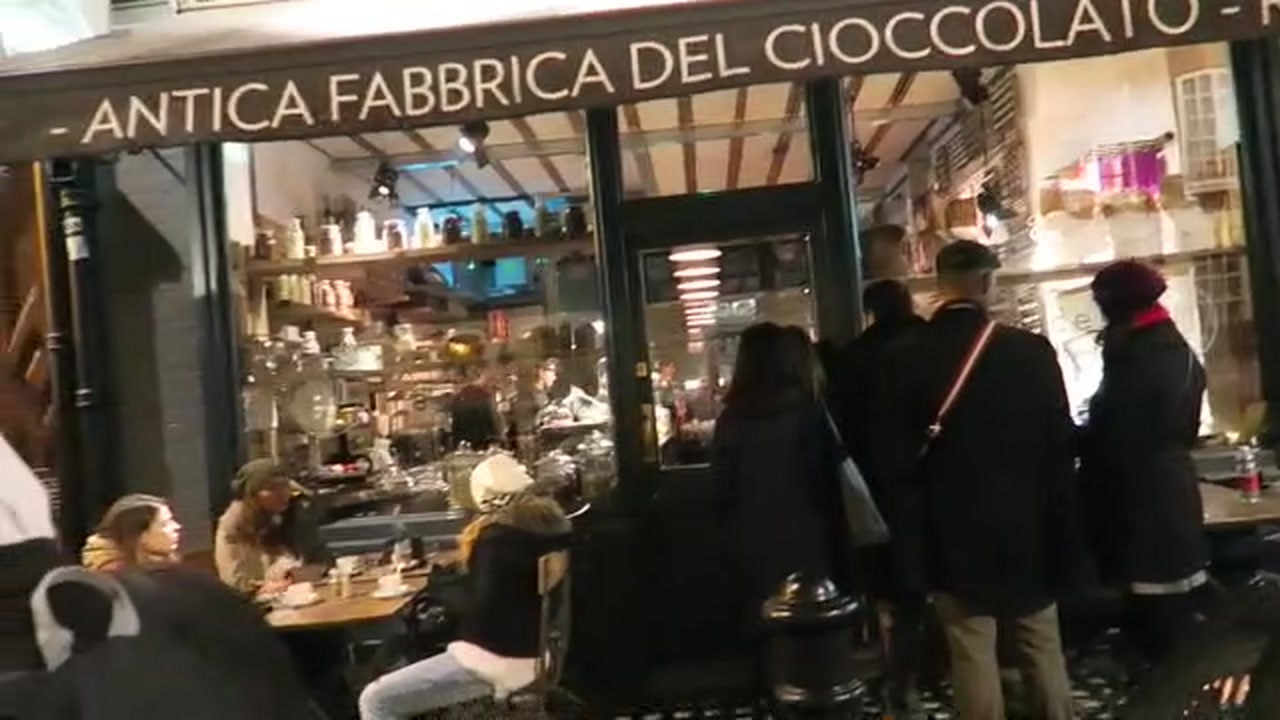 Customers outside the illuminated SAID chocolate shop in Soho in 2016