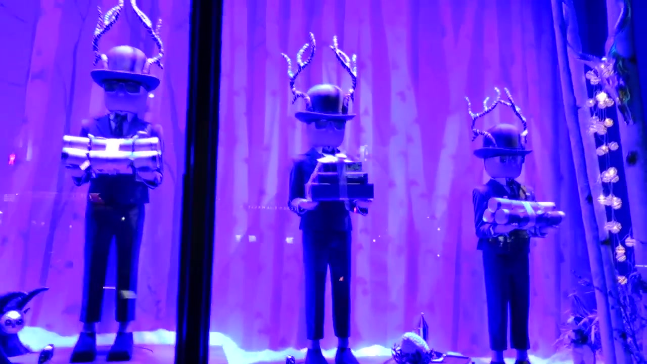 Toy soldiers carrying gifts in a violet Harrods Christmas window