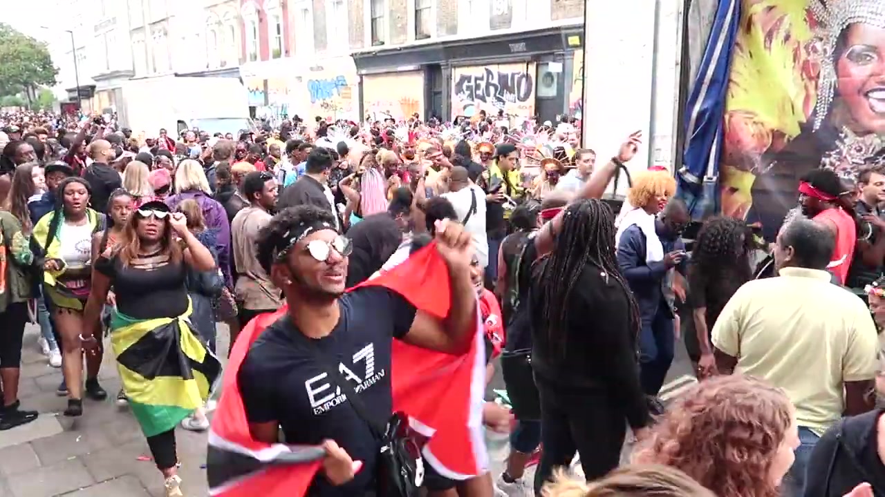 Spectators and stewards beside the crowded Notting Hill Carnival parade route in 2018