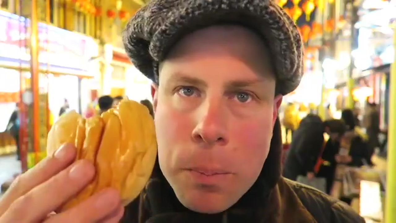 Barry Roberts holding an opened char siu bun in London’s Chinatown