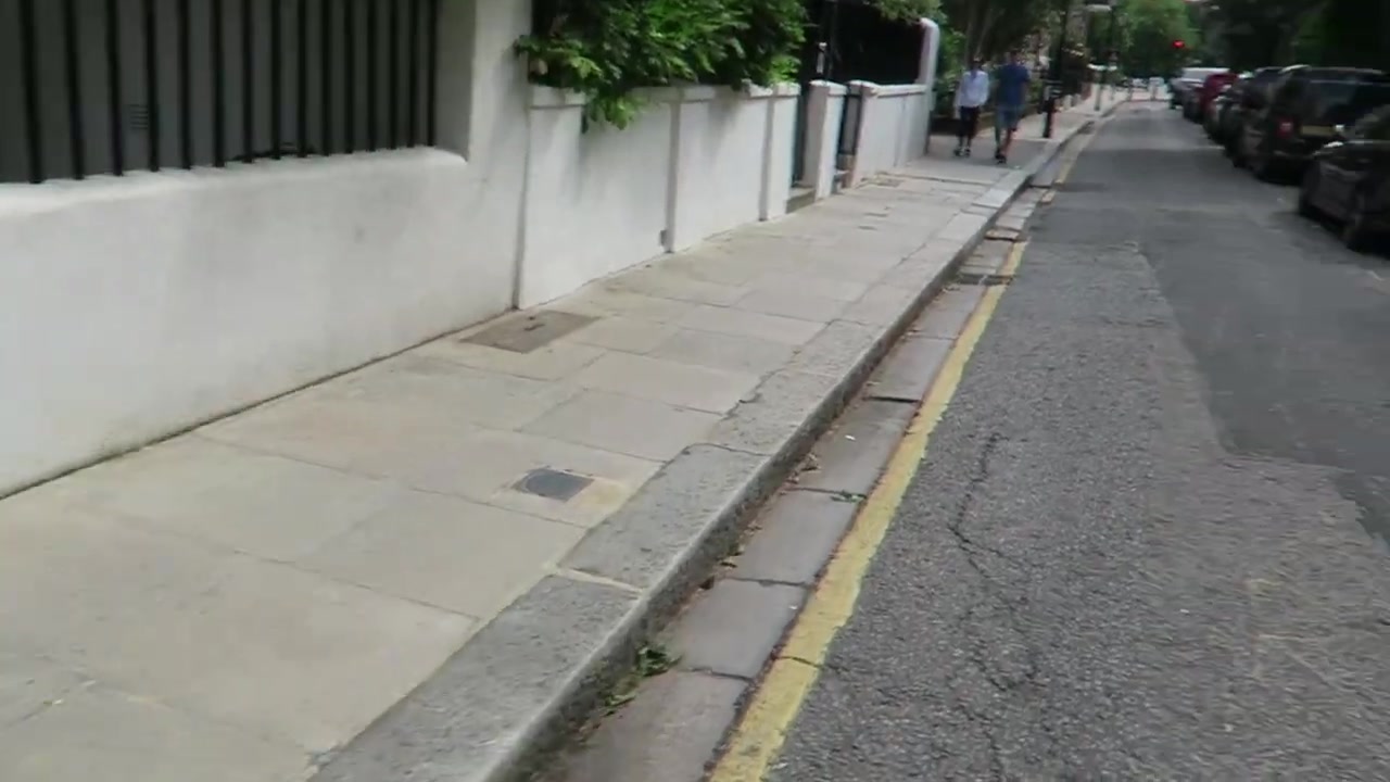 Black iron railings and a white garden wall along Cheyne Walk